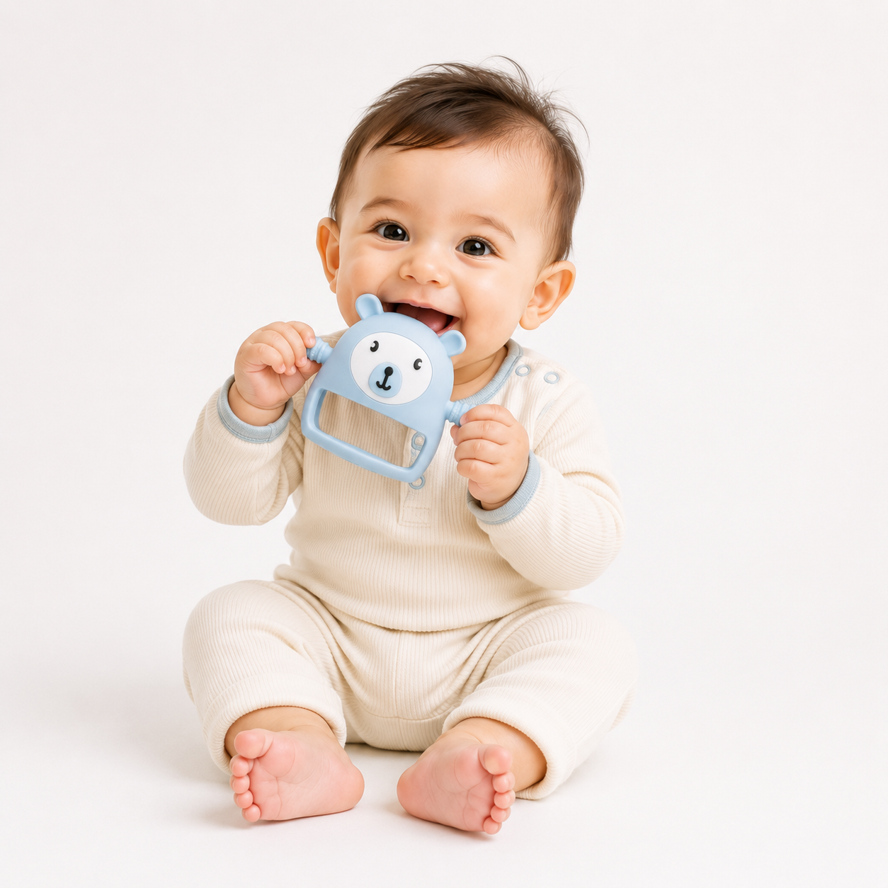 Baby holding a blue teether toy